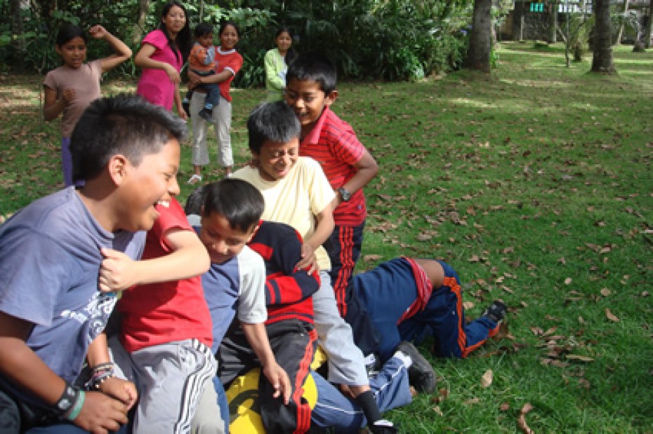 group of young children outside playing games and laughing