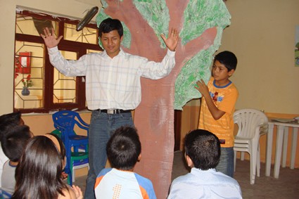 young man teaching children