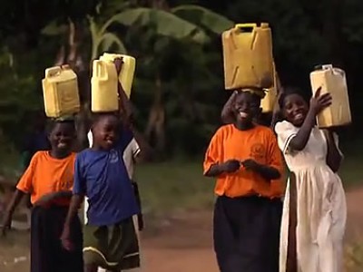 children carrying water jugs on their heads