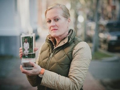 woman holding up photo of child
