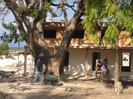 Two construction workers outside of a new building.