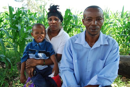 Man, woman and child sitting outside