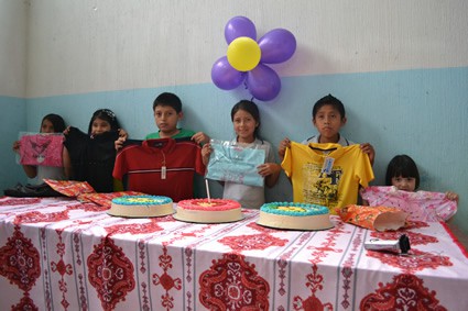 Children at a party with cakes.
