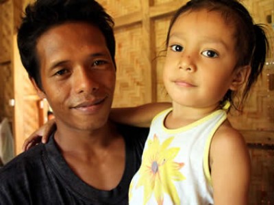 Filipino man holding child