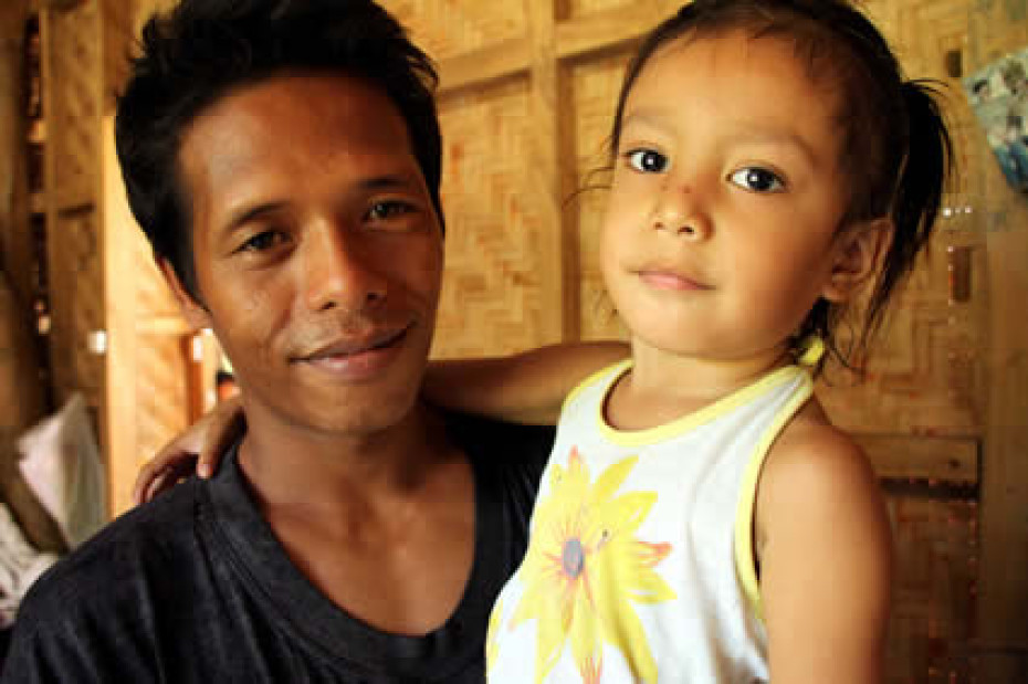 Filipino man holding child