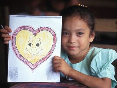 girl holding paper heart