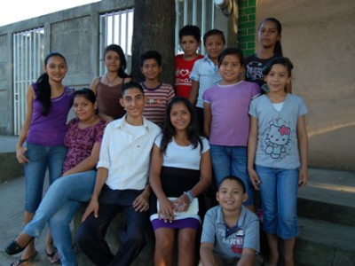 a group of children standing in front of a building