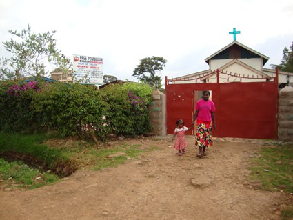 woman and girl holding hands outside of a church