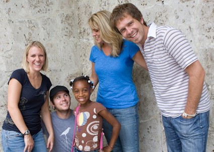 Robbie Seay band members with sponsored child in the Dominican Republic