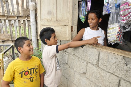woman selling snacks to two boys