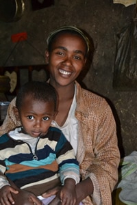 woman holding boy in her lap