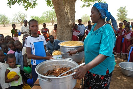 woman serving a meal to children