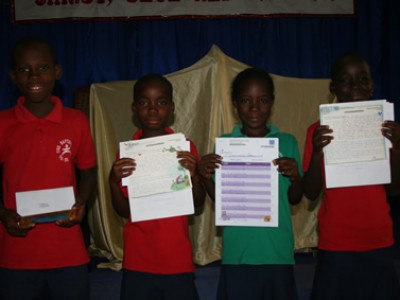 four children holding up letters
