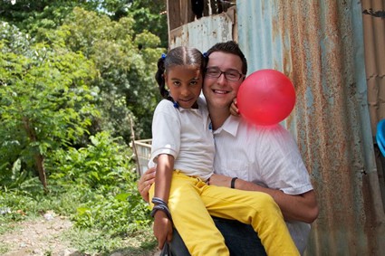 man holding a girl holding a red balloon