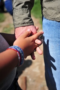 hands of two people holding hands