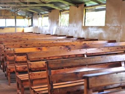 wooden benches inside Kenyan church