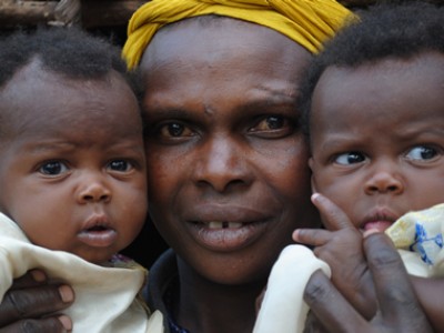 close up of woman holding two babies
