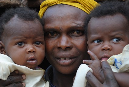 woman holding two babies