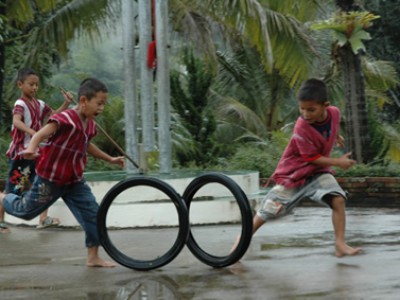 children rolling tires in a race