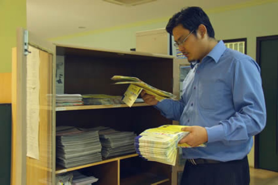 sorting-letters-IN A man reading some papers