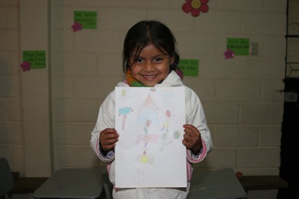 smiling girl holding picture