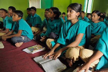 several boys and girls in a classroom