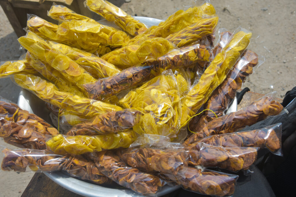 A bowl of dried plantains wrapped in plastic bags.