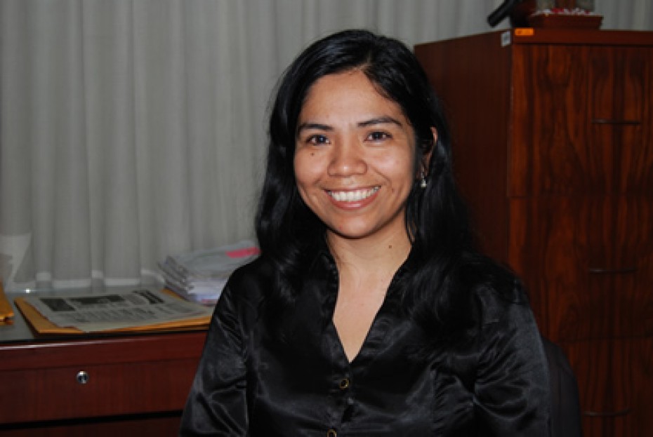 a youg smiling woman in a black blouse in an office
