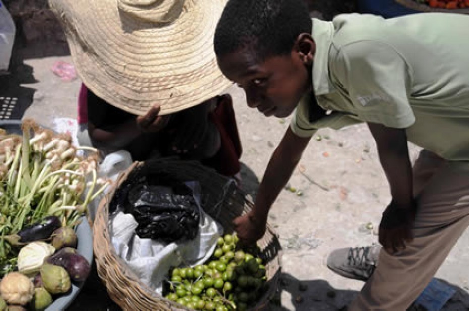 a boy looking at a basket of food