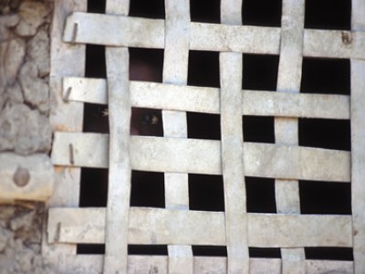 Lattice covering a window opening.