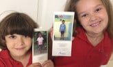 two children holding photos of sponsored children