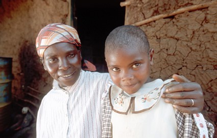 smiling woman with arm around smiling girl