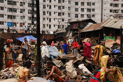 people in colorful clothing in poor area of a town