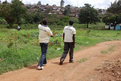 two people walking on a dirt road