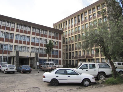 office building with cars parked outside