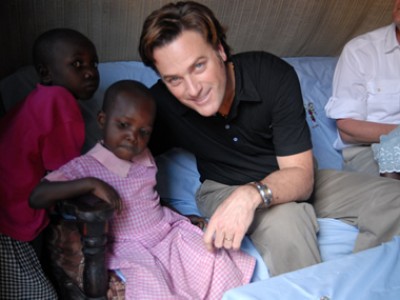 Michael W. Smith sitting with two Kenyan children