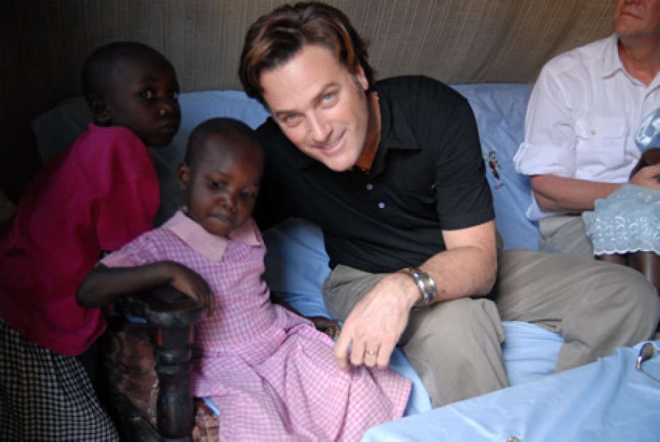 Michael W. Smith sitting with two Kenyan children