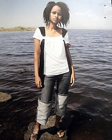 young woman standing at the edge of water