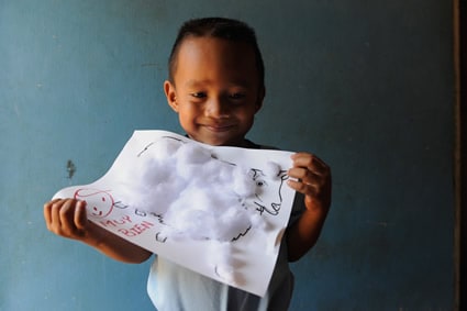 boy holding drawing of sheep