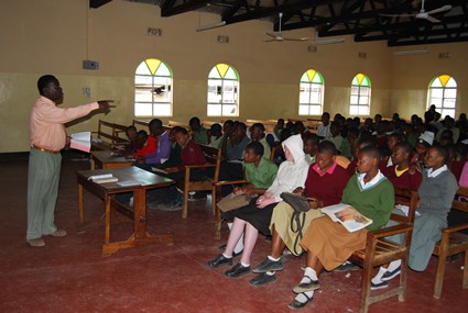 man teaching a group of children