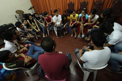 group of teens sitting in a circle