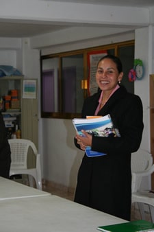 smiling woman standing holding books