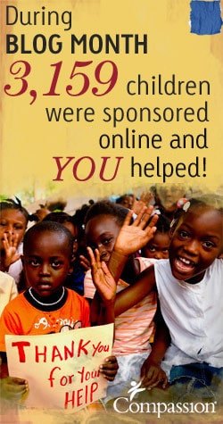 laughing children with boy holding thank you sign