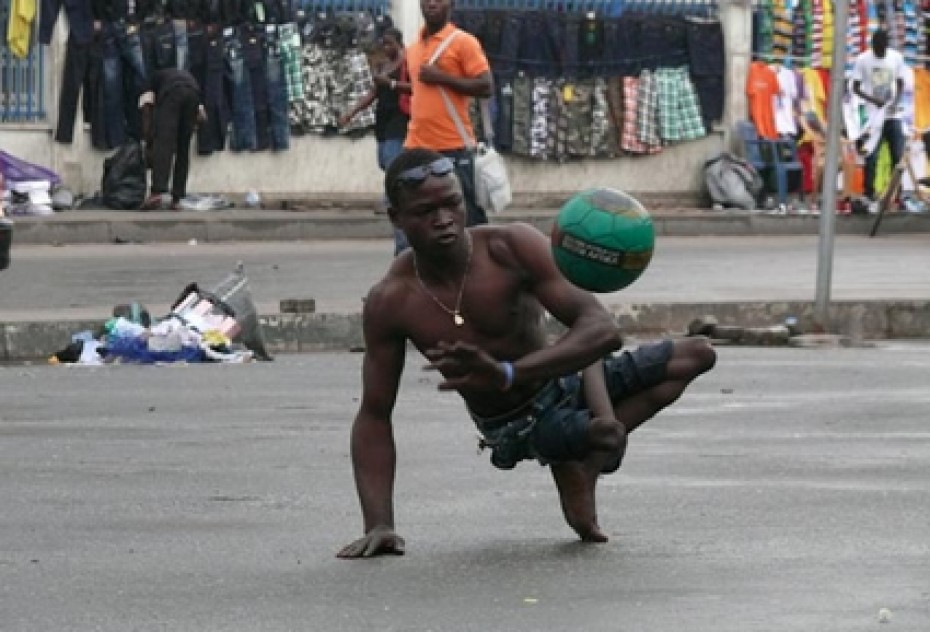 man on the street with a soccer ball