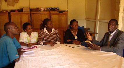 men and women sitting around a table having a discussion