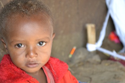 young child wearing read jacket