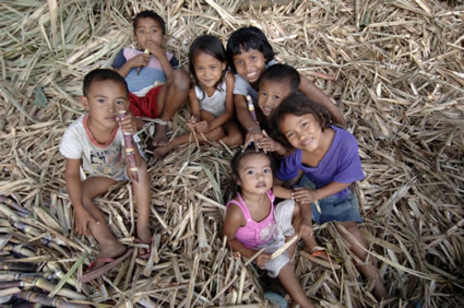 group of children sitting in hay