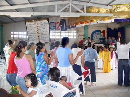 group of people watching children perform in a church