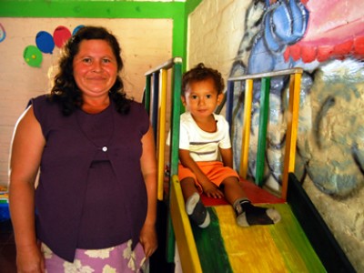 woman next to child on slide