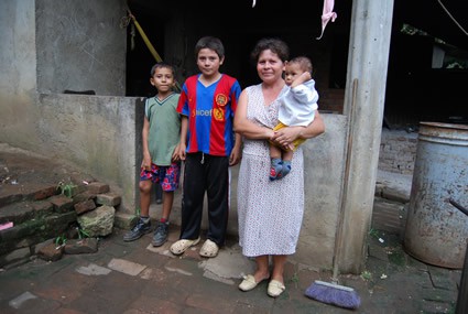 woman holding baby standing with two boys